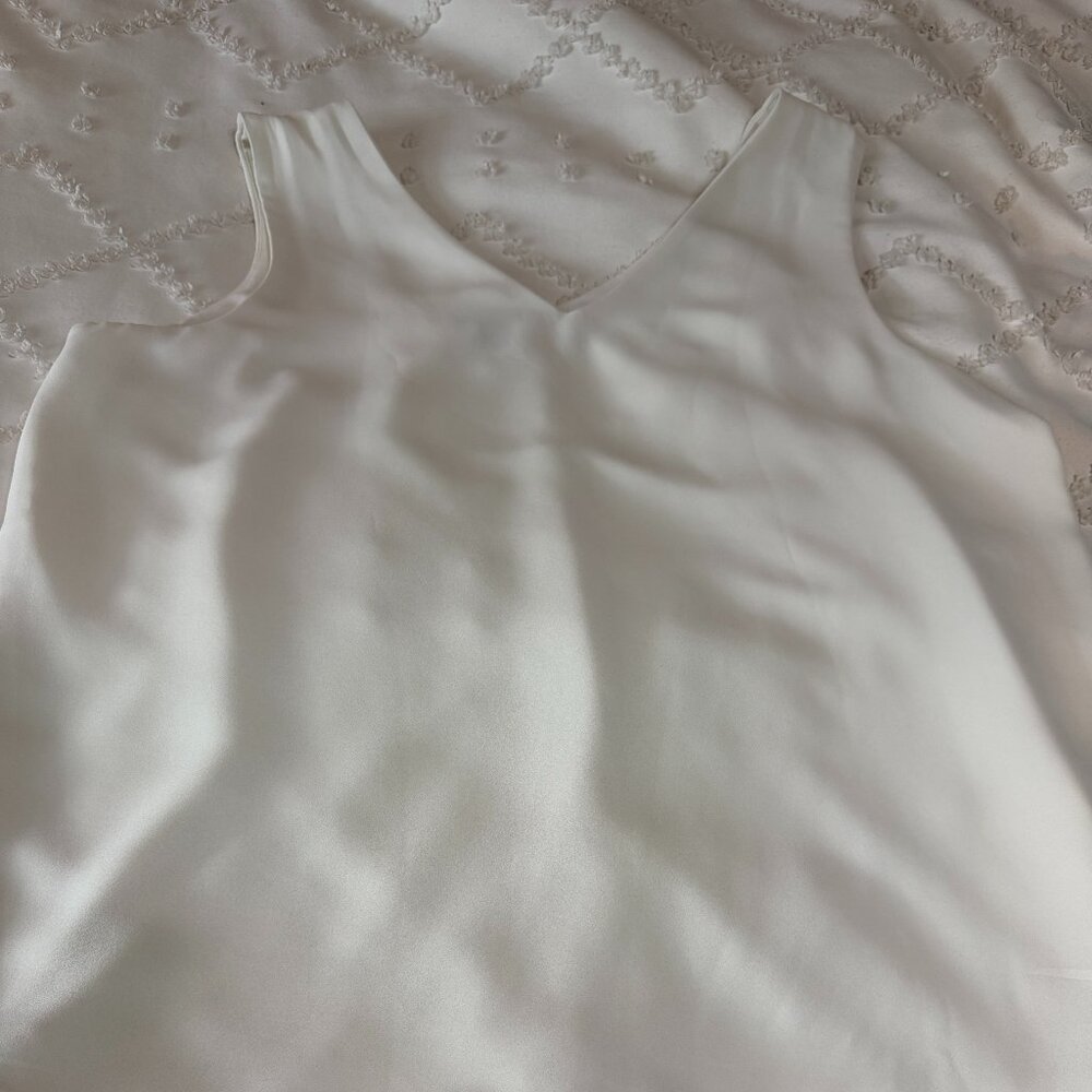 Cream sleeveless blouse